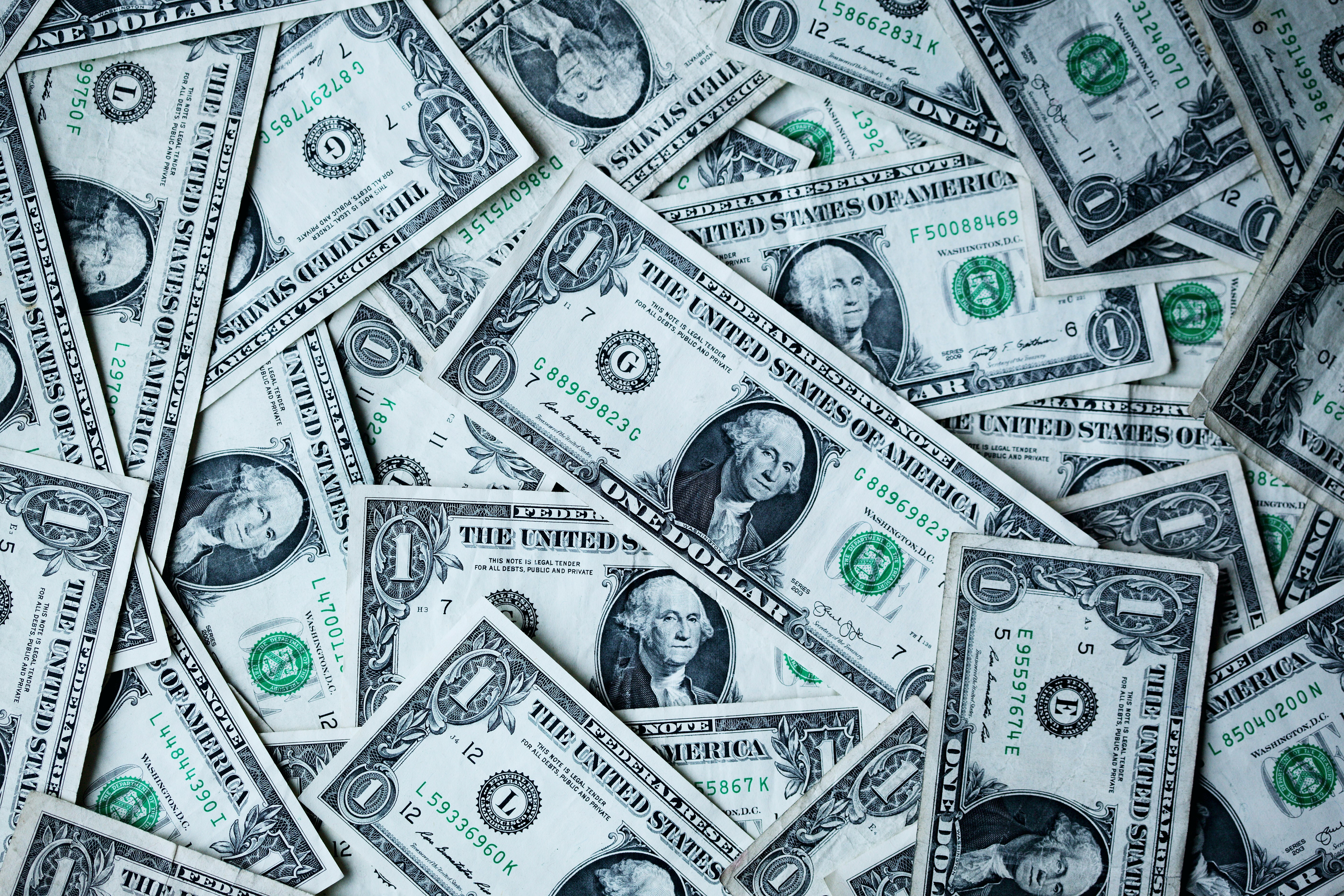 Pile of US dollar bills representing debt and income in mortgage qualifying