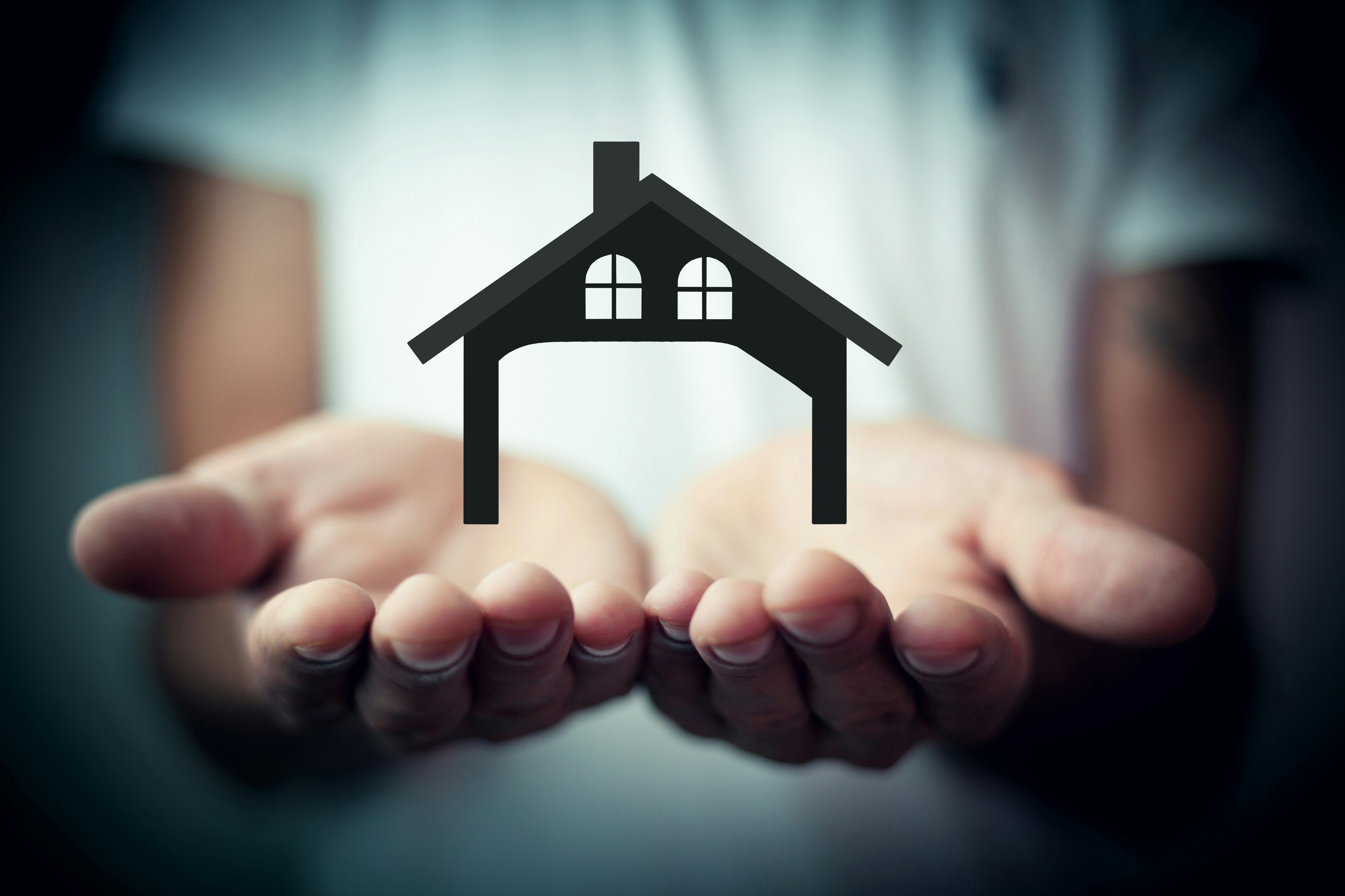 Hands holding a home — working with a mortgage broker