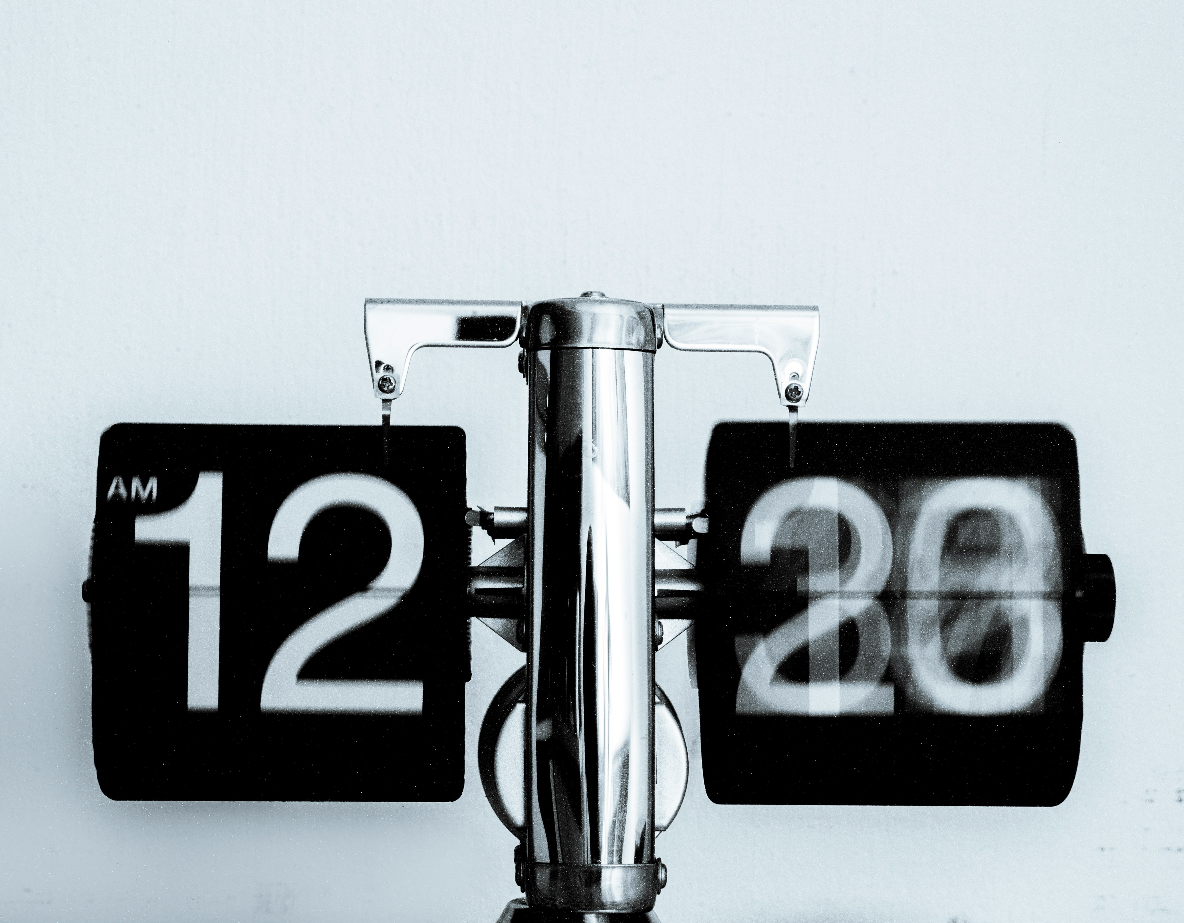 Flip clock showing 12:20 representing the mortgage closing timeline